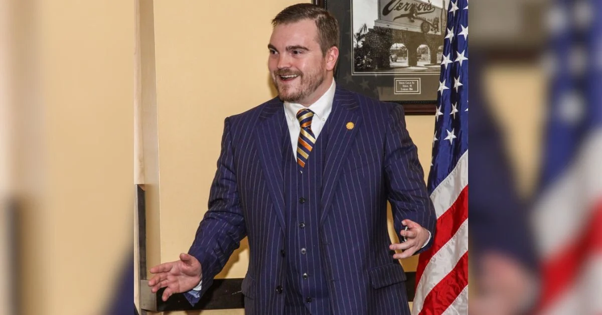 Beau LaFave speaking with American flag