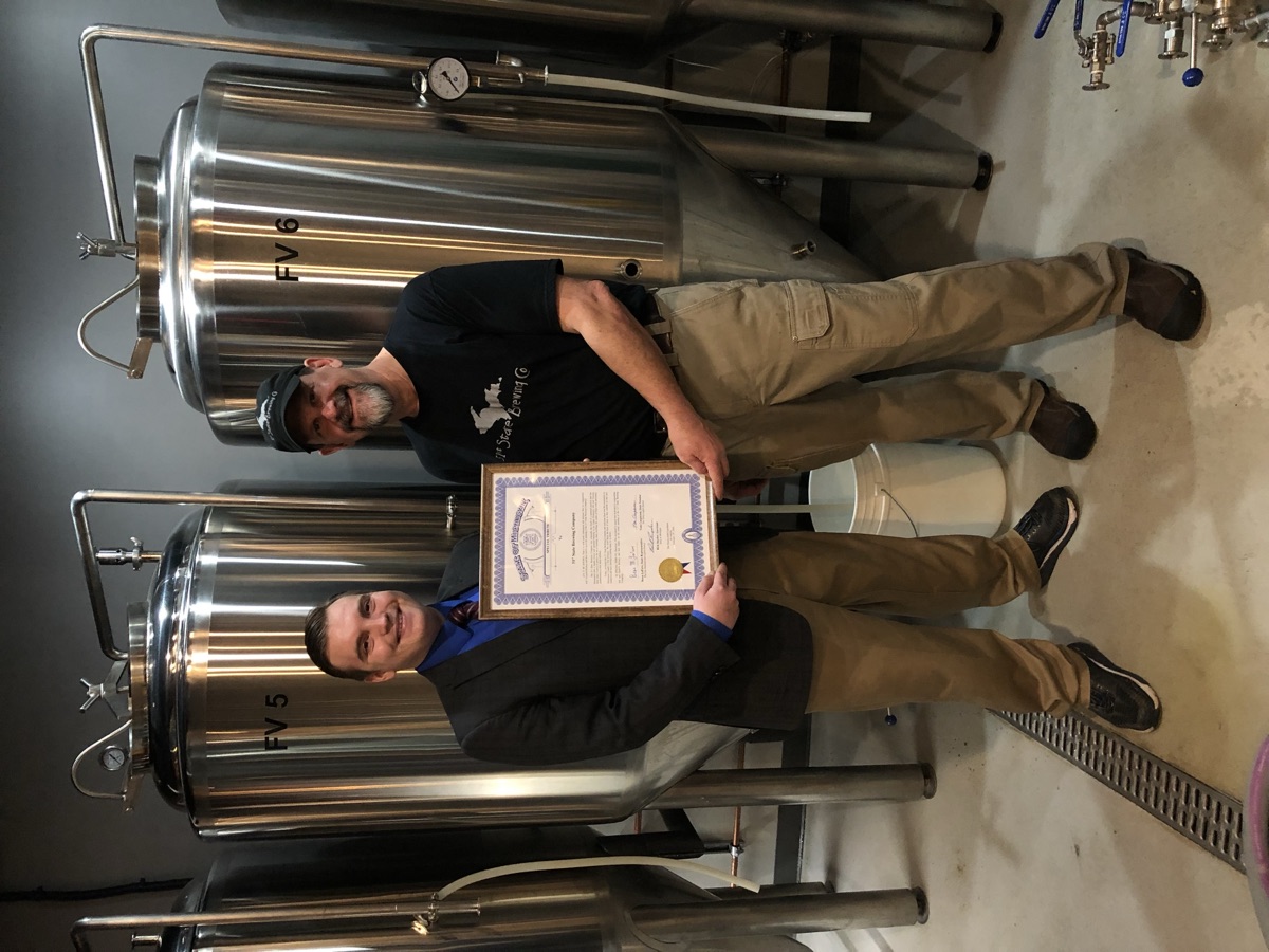 Beau LaFave presenting a legislative tribute to 51st State Brewing Company